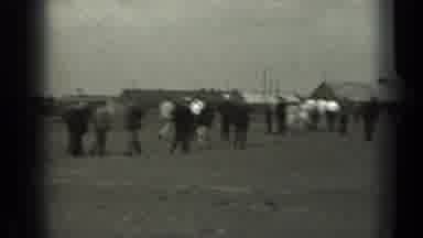 Missouri USA (1961): Multiple People Walking Towards A Small Village With A Big