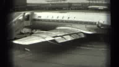 Missouri USA (1961): Airplane Sits On Tarmac As Worker Towards It's Rear Tows A