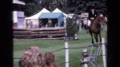 England-1963: Horse Galloping Through Fairgrounds With People Watching On A
