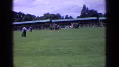 England (1963): The Little Dog Running And Other People Watching With Their Dogs