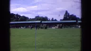 England (1963): People Walking With Dog On Green Grass On A Clear Day