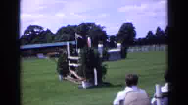 England (1963): Crowd Watching Person Ride A Horse And Jump Over Fences For