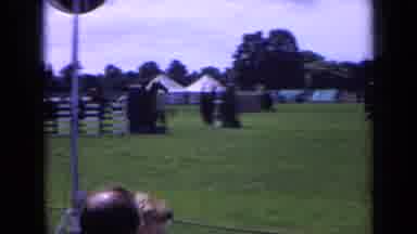 England (1963): Person Riding Horse Through Obstacle Course While Crowd Watches