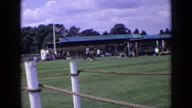 England (1963): Man Riding A Racing Horse Carriage In A Field While People Stand