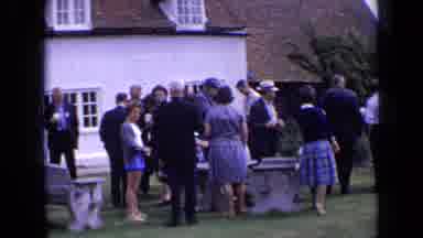 England (1963): A Bunch Of People Are Gather Around Each Other For An Occasion