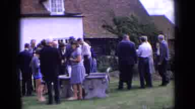 England (1963): People In Social Suits Gathering In Front Of A House To Talk