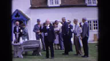 England (1963): People Gathered Talking Outside A White Church By Day