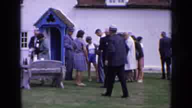 England (1963): Gathering Of Well Dressed People Outside For A Social Occasion