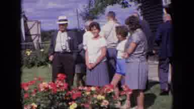 England (1963): A Small Family Gathering Around A Flower Bed About To Pose For