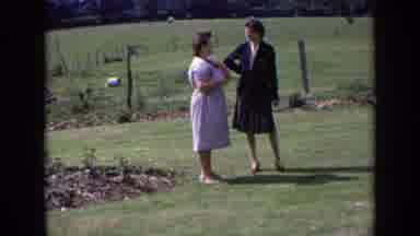 England (1963): Two Women Wearing Dresses Standing In A Field Talking