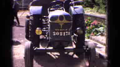 France (1963): A Young Boy Outside Inspects An Old Blue Tractor