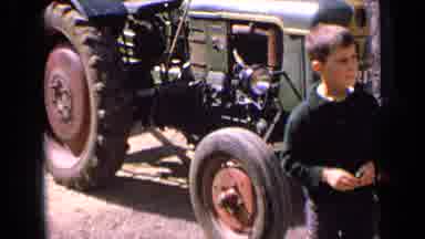 France (1963): A Little Boy Wearing A Green Sweater Stands In Front Of A Green