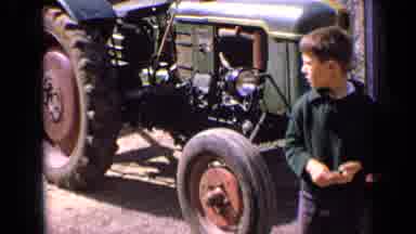 France (1963): Boy Wearing Green Sweatshirt Stands Next To Green Tractor On A