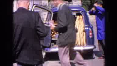 France (1963): Man Purchasing A Bakery Product Out Of The Back Of A Man's Vehicle