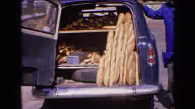 France (1963): Baker Displaying Variety Of Fresh-Baked Bread From The Back Of His