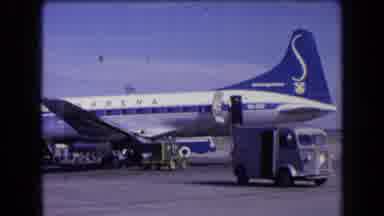 France (1963): Crew Members Load Luggage Onto Blue And White Jet Plane On A Clear