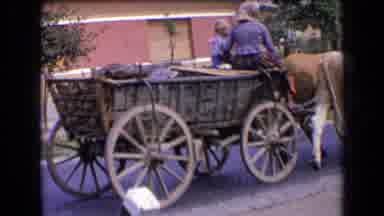 France (1963): Woman And Child Ride In Bovine Pulled Cart Down Street Scene Of