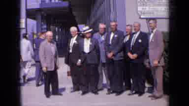 London England-1963: Men Pose For Photo At Company Entrance On Sunny Day For