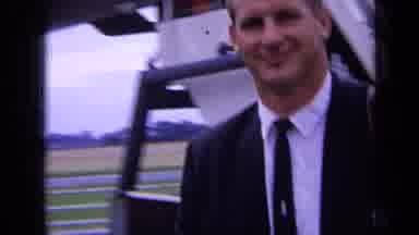 London England (1963): Man Getting Off Plane While Woman In Blue Stands And Waits