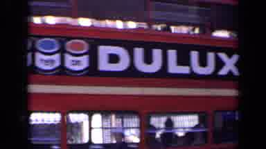 London England (1963): Double Decker Bus Driving By On A Sunny Day