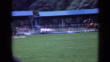 London England (1963): Person Riding Horse Through Obstacle Course While Crowd
