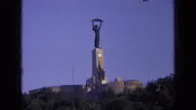 Russia (1963): Black Statue Holding Overhead Over Rock Monument On Top Of Mountain
