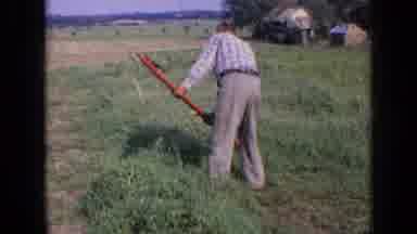Russia (1963): I See A Farmer Trying To Get Rid Of The Weed By Using A Long Red
