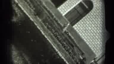 Russia (1963): Woman Wearing White Hat Sweeps White Object With Broom On A Sunny