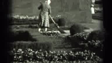 Russia (1963): A Woman In A Dress With Something On Her Head Sweeping The Ground