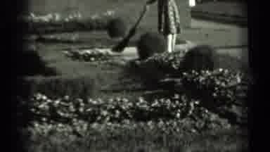 Russia (1963): Woman In Floral Dress Sweeping Garden Sidewalk Cut To A Wall Of
