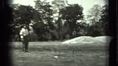 RUSSIA-1963: Two Men in a Grass Field with Sand Mounds and Machinery