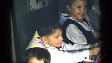 New York (1948): Boy Wearing Blue Shirt And Yellow Birthday Hat Talks To Kids