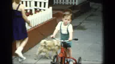 New York (1948): A Small Kid Having Fun On A Bicycle A Group Of People Wave