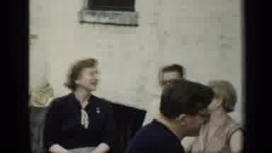 New York (1948): Fellow Dressed In Black Turns His Chair Smiles Looks At Woman Who