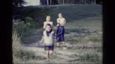 New York (1948): Girl Wearing Blue Dress Runs Toward Camera On A Clear Day