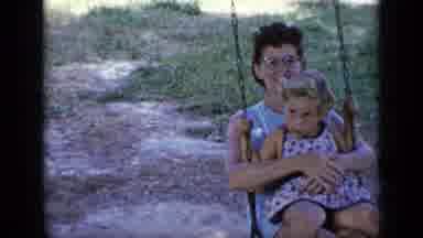 New York (1948): Woman Tells Child To Smile As They Move Back And Forth On Swing