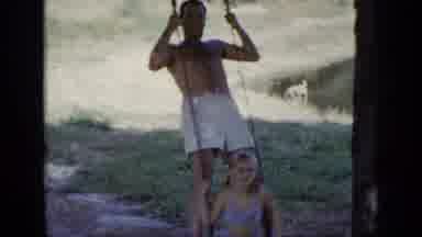 New York (1948): Man Stands On Swing Above Little Girl Who Is Smiling
