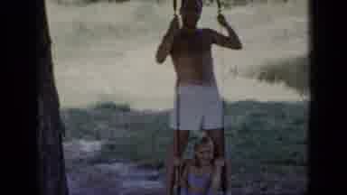 New York (1948): Teenage Boy Playing And Splashing While On A Inner Tube In Water