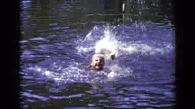 New York (1948): Young Boy Happily Splashing And Swimming By Himself In The Water