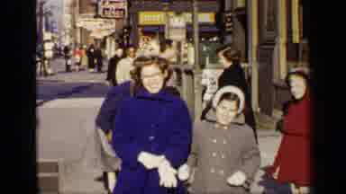 New York (1948): Smiling People With Colorful Overcoats Walking On The Street At