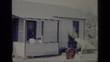 New York (1948): One Story White House Shown With Man Opening Door And Raising His