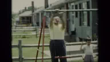 New York (1948): Dad Building Swing Set While Son Plays On Swing Next To Him