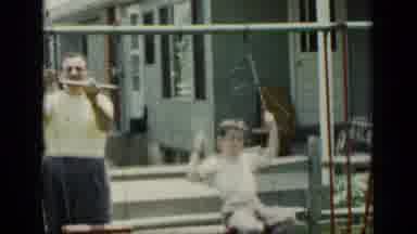 New York (1948): Dad Building Swing Set While Son Plays On Swing Next To Him