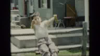 New York (1948): Young Boy Swinging On A Swing With Dad In The Yard On A Warm Day