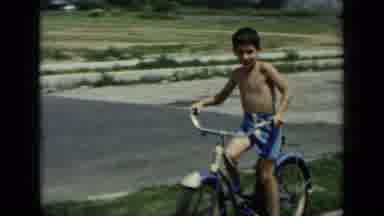 New York (1948): Shirtless Kid On Bike Riding Towards Camera