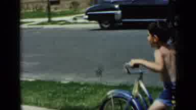 New York (1948): A Very Young Child Learning To Ride A Bicycle In Front Of His