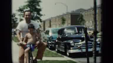 New York (1948): Father And Son Riding On A Bicycle Down The Sidewalk On A Sunny