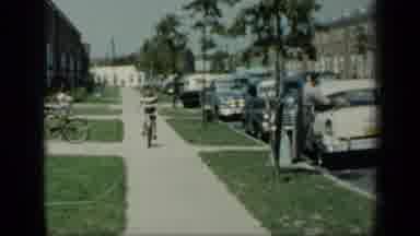 New York (1948): Little Boy Riding His Bike Down A Sidewalk As A Man Cleans His