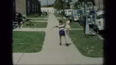New York (1948): Young Boy Wearing Roller Skates Skating Up And Down A Sidewalk