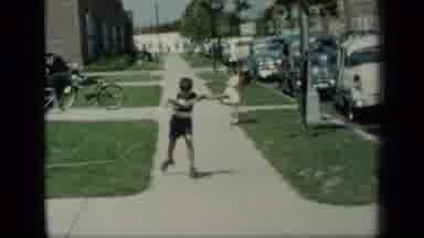 New York (1948): Boy Wearing Black Shorts Roller Skates On Sidewalk On A Bright